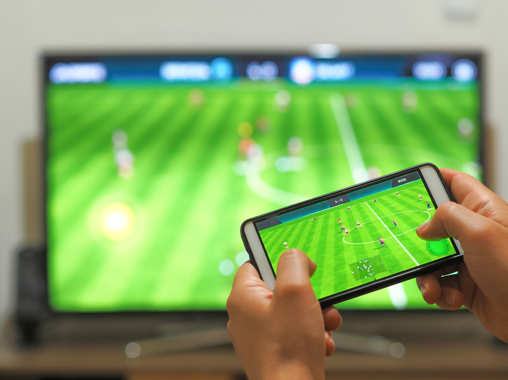 Playing,Soccer,On,A,Tv,With,A,Smartphone