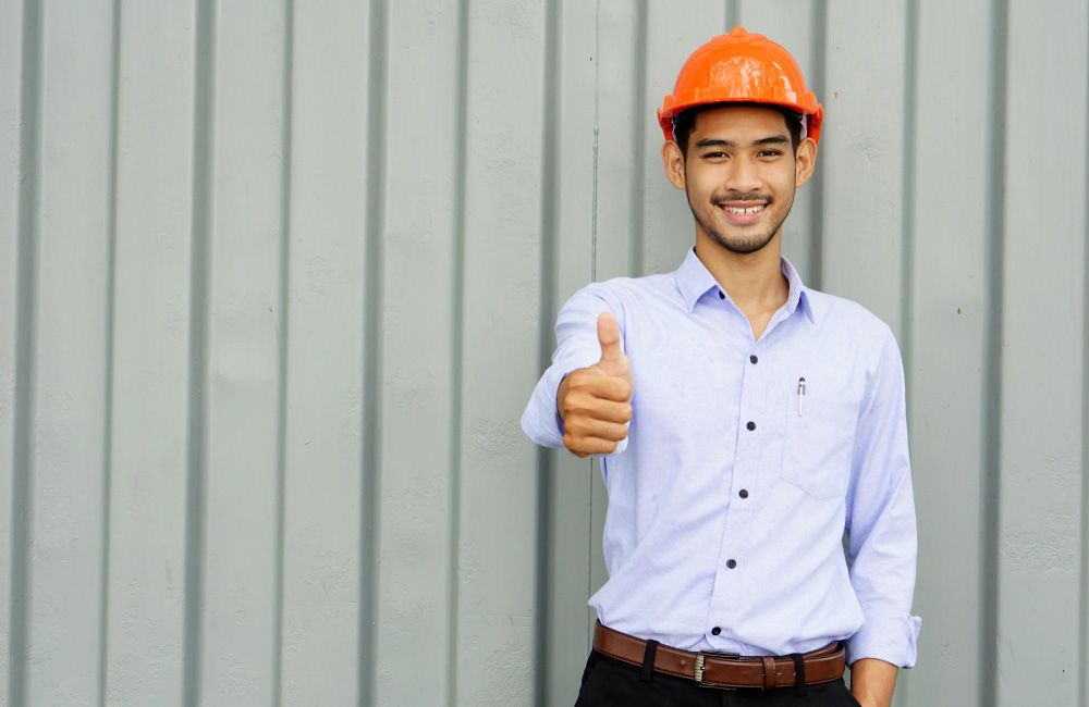 Handsome,Engineer,Wears,Orange,Safety,Helmet,Shows,Thumb,Up,With